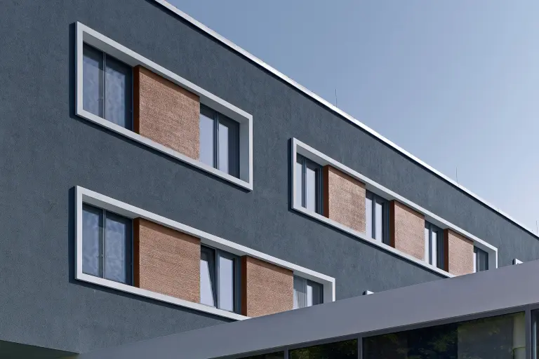 Fassadendämmung: Außenaufnahme eines Apartmenthauses, anthrazitfarbene, mit Sto gedämmte Fassade