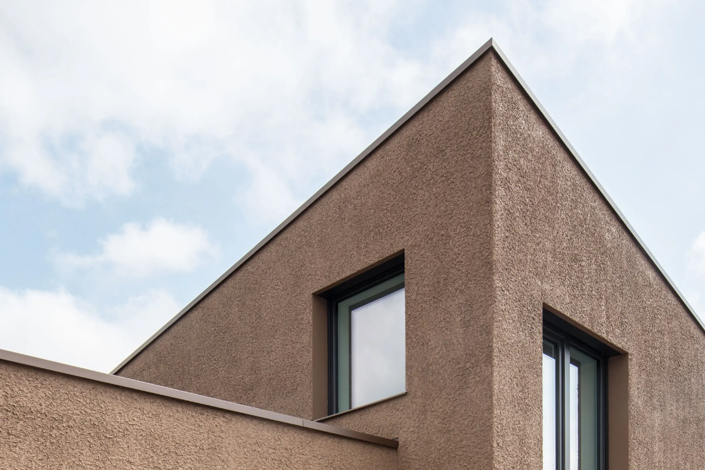 Residential building facade, rendered with rolled coarse render texture using Sto ETICS